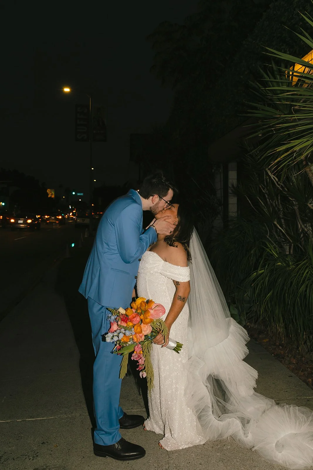 A bride and groom taking outdoor wedding photos