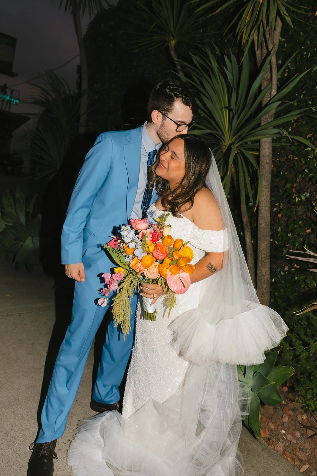 A bride and groom taking outdoor wedding photos