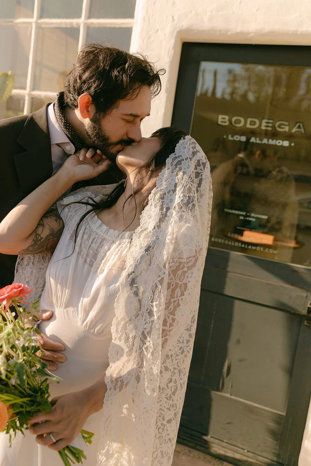 A bride and groom kissing at their dinner party wedding