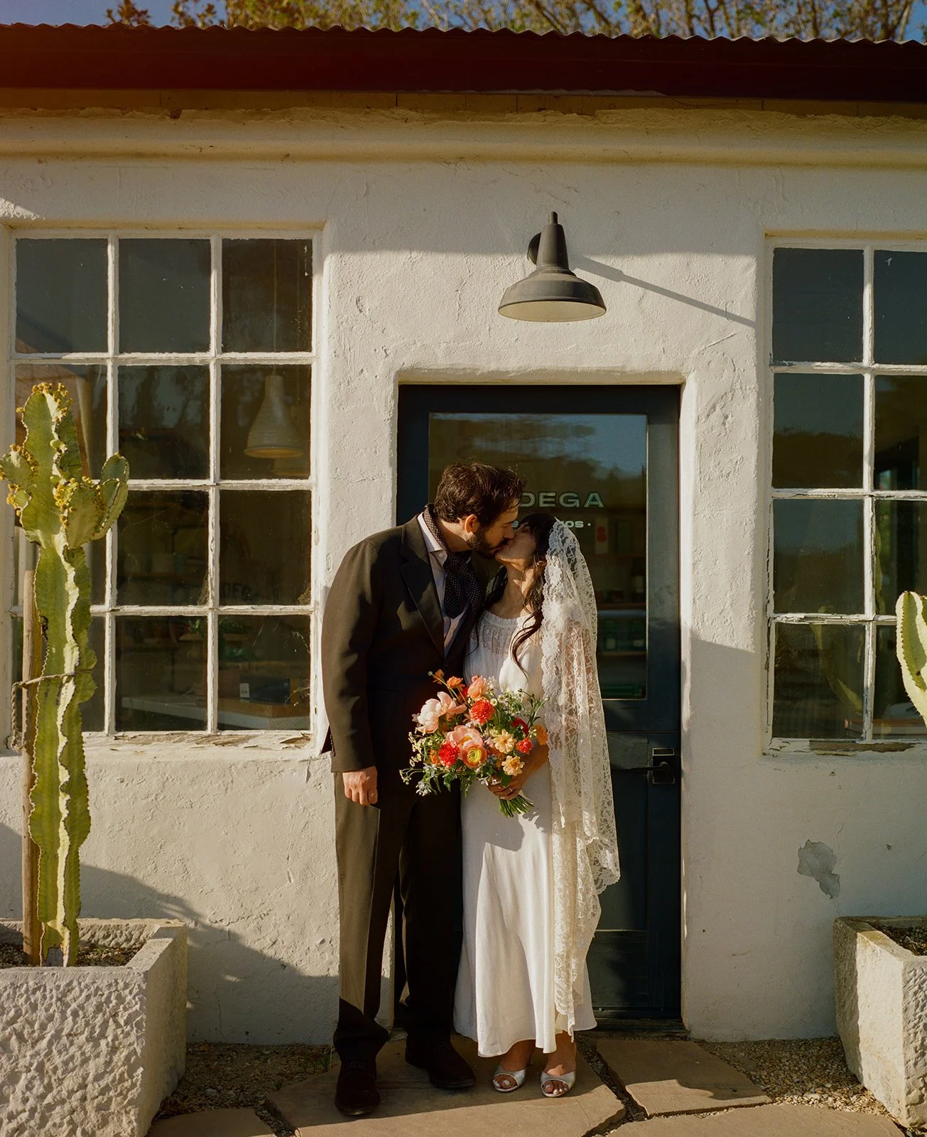 A bride and groom kissing at their dinner party wedding