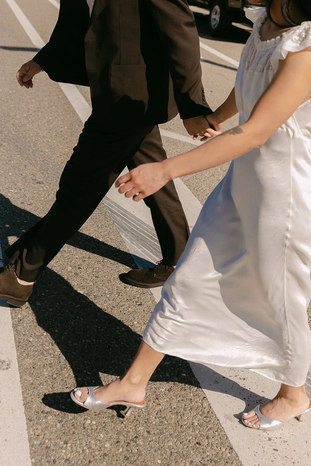 A bride and groom taking wedding photos on a city street