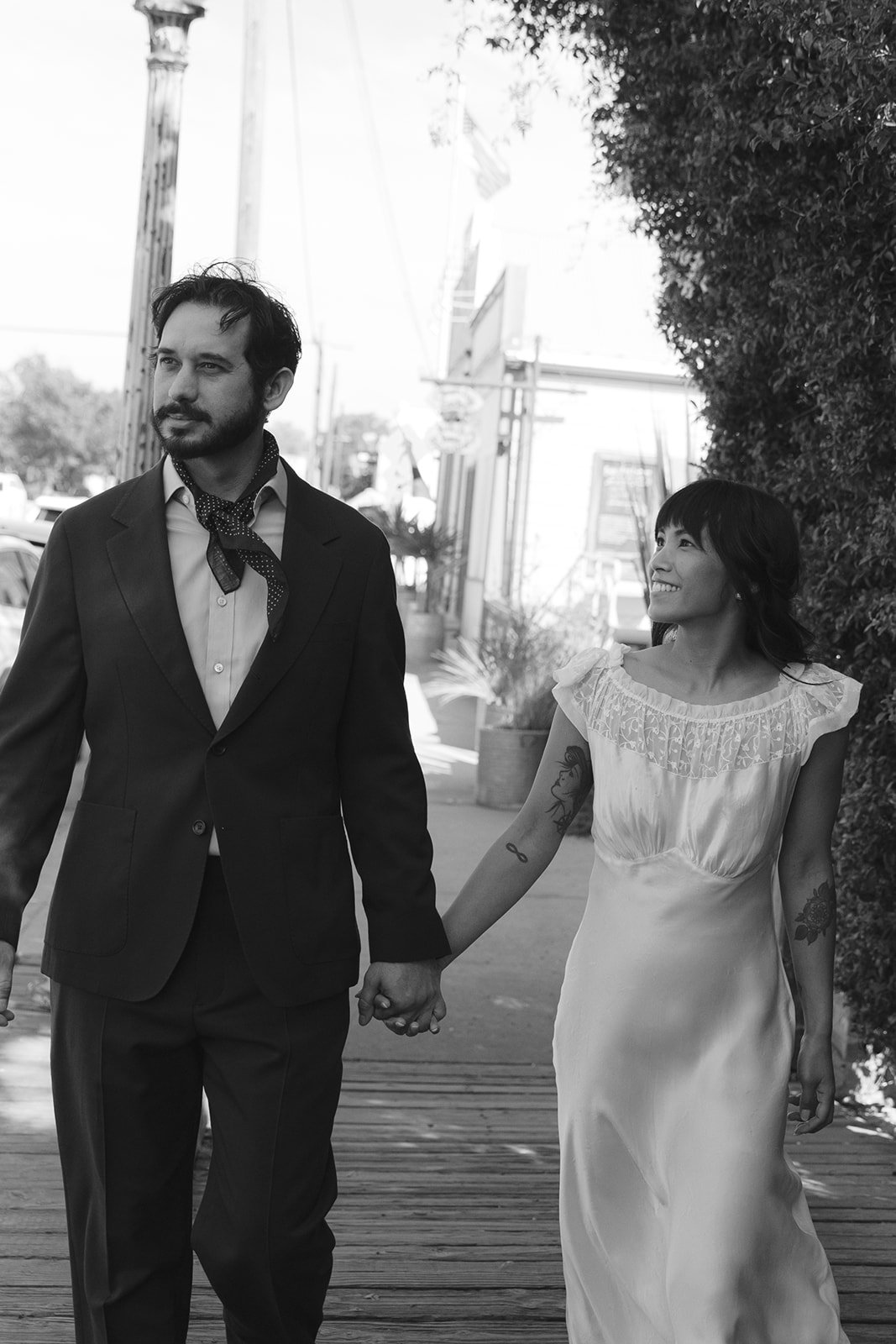 A bride and groom taking wedding photos on a city street