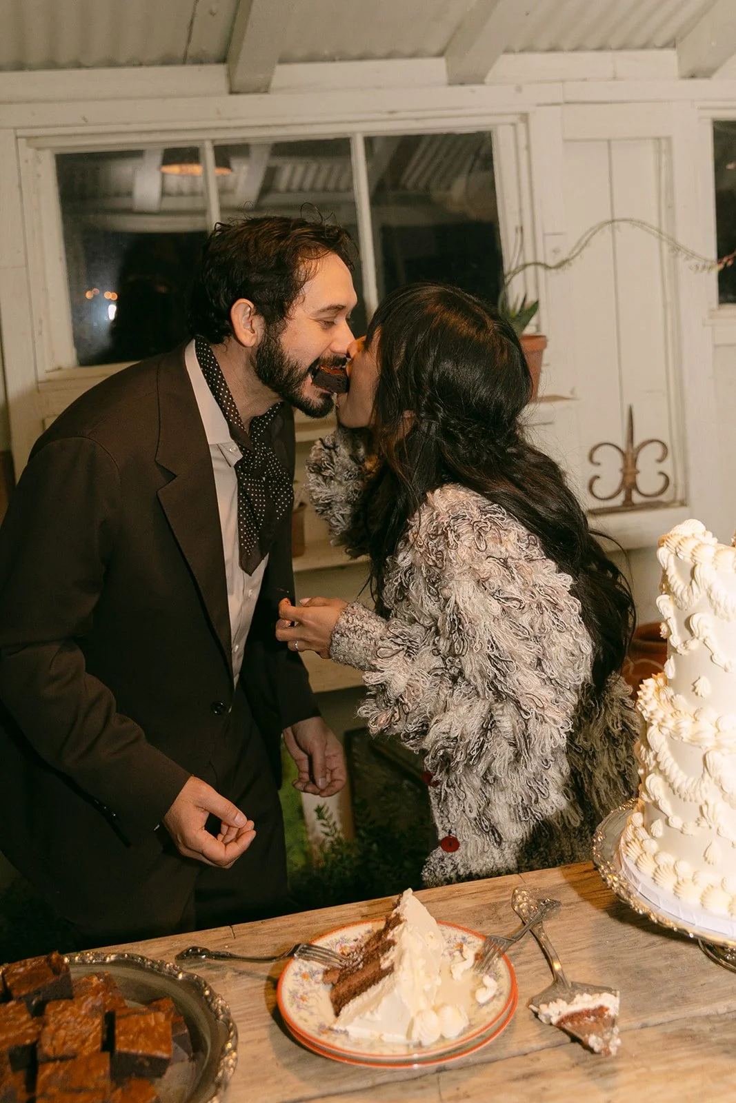 A bride and groom cutting their wedding cake