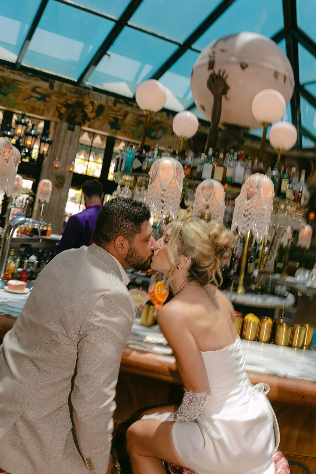 A couple taking Lafayette Hotel engagement photos at a bar