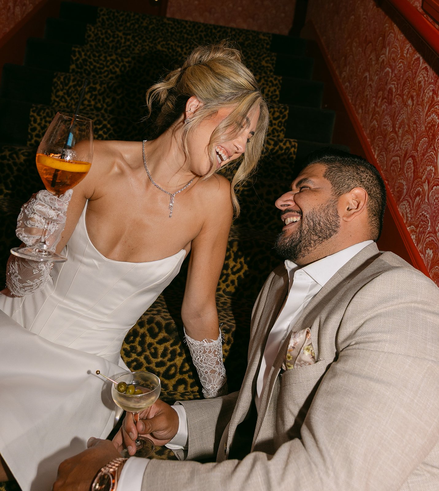 A couple in a hallway with cheetah print stairs