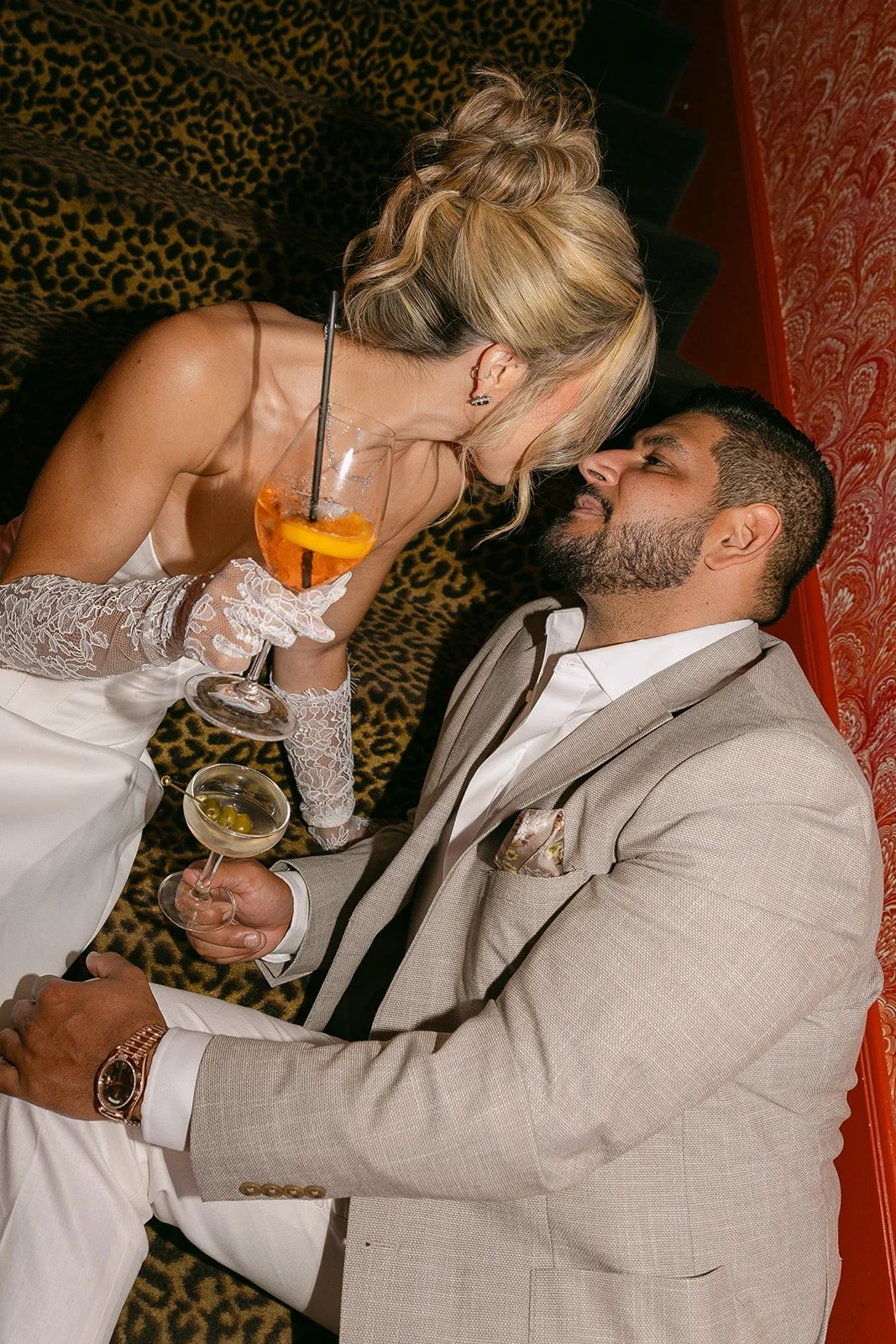 A couple in a hallway with cheetah print stairs