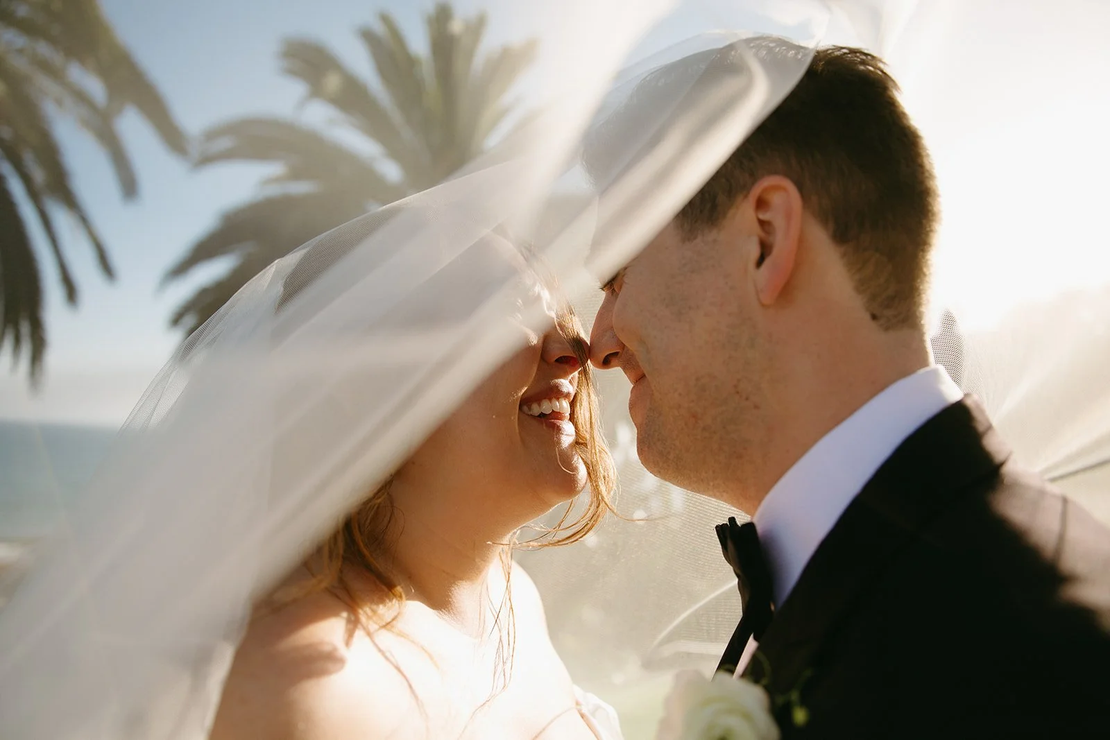 A bride and groom taking summer wedding photos