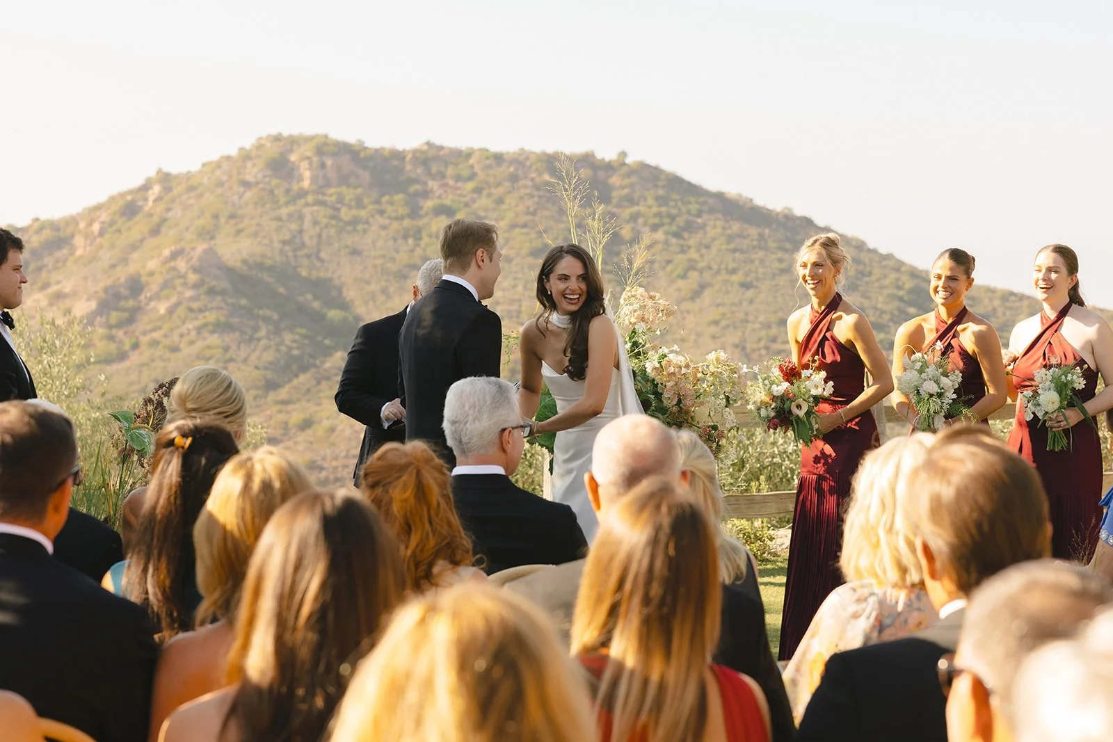 A bride laughing during her wedding ceremony