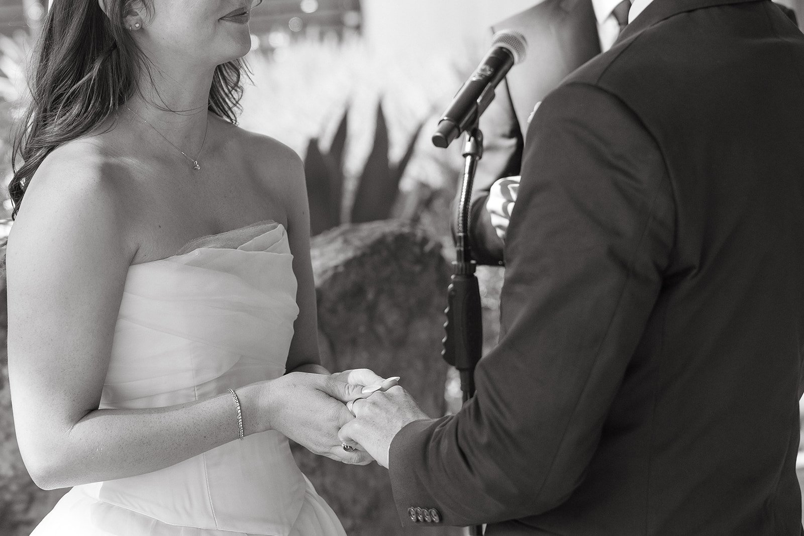 A bride and groom holding hands during a small wedding ceremony