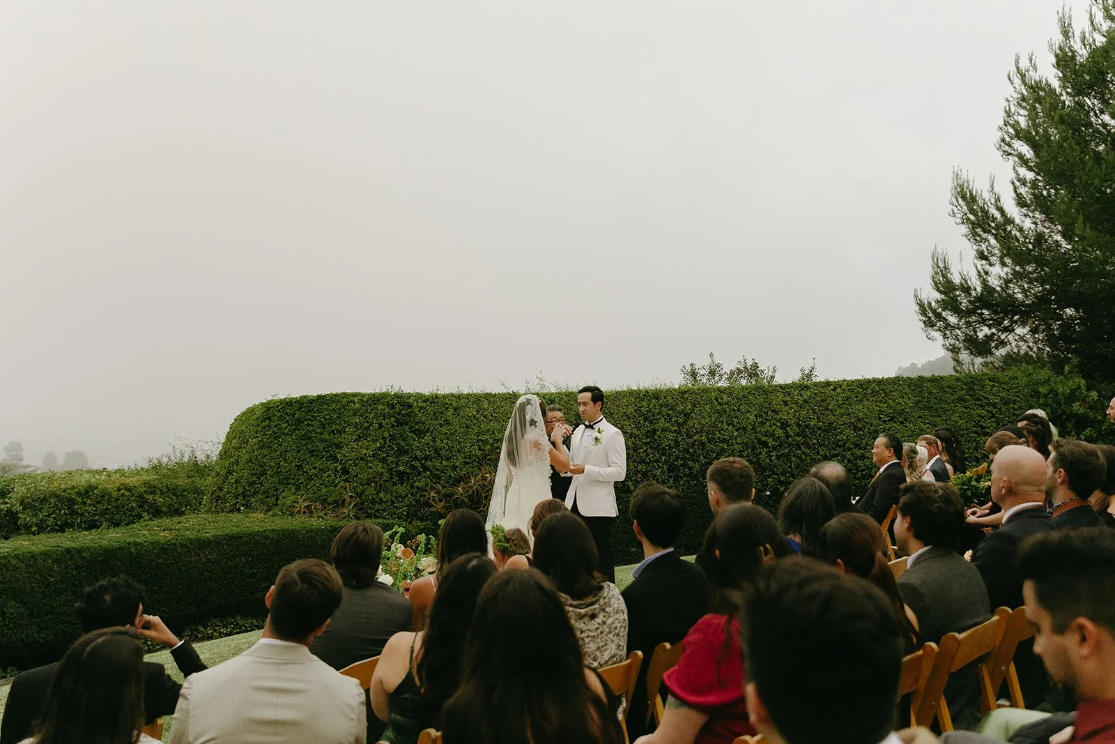 Wide view of the outdoor ceremony overlooking the coastline at one of California’s Historic Wedding Venues.