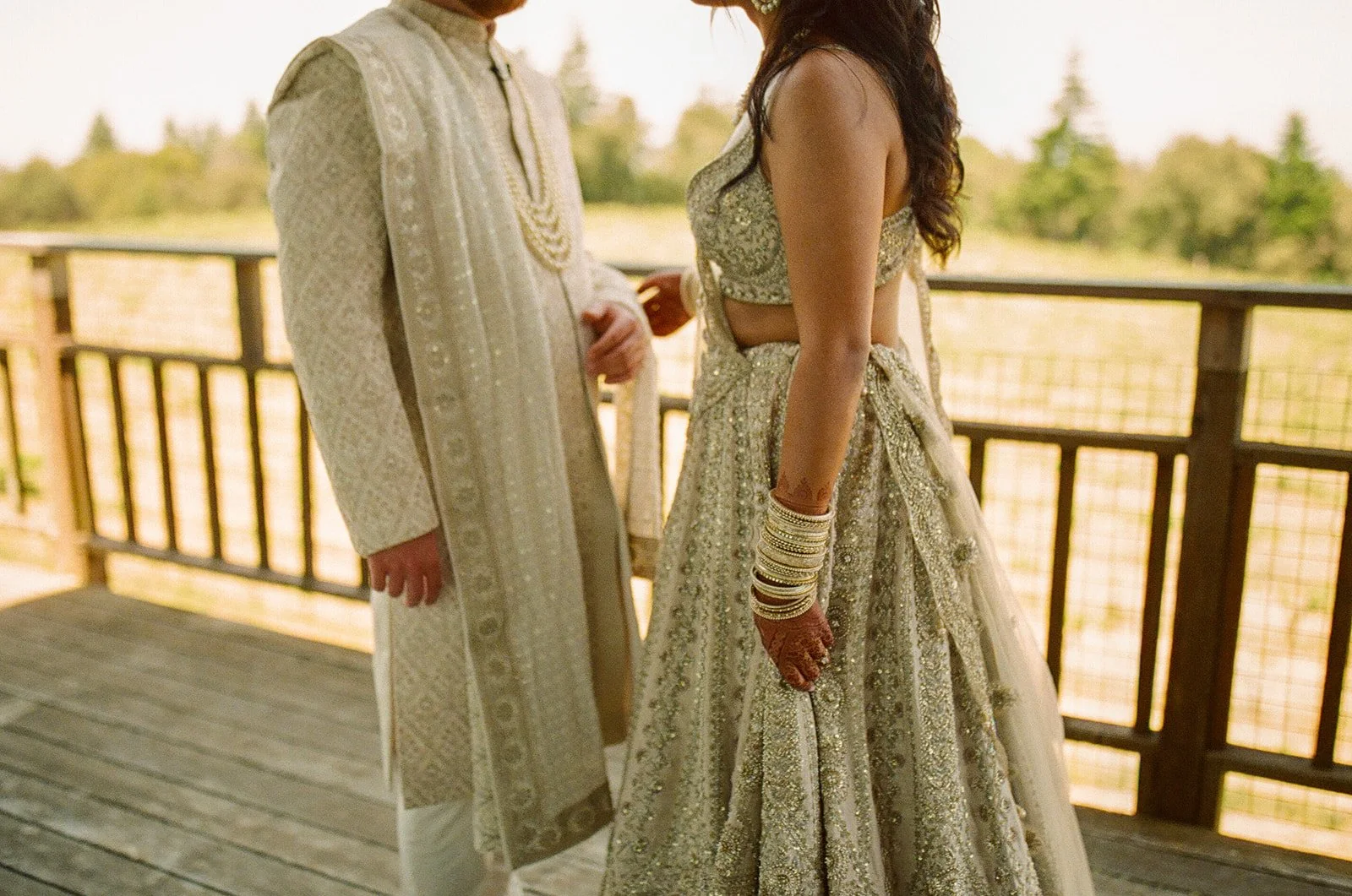 A bride and groom in traditional Indian wedding attire, honoring wedding traditions