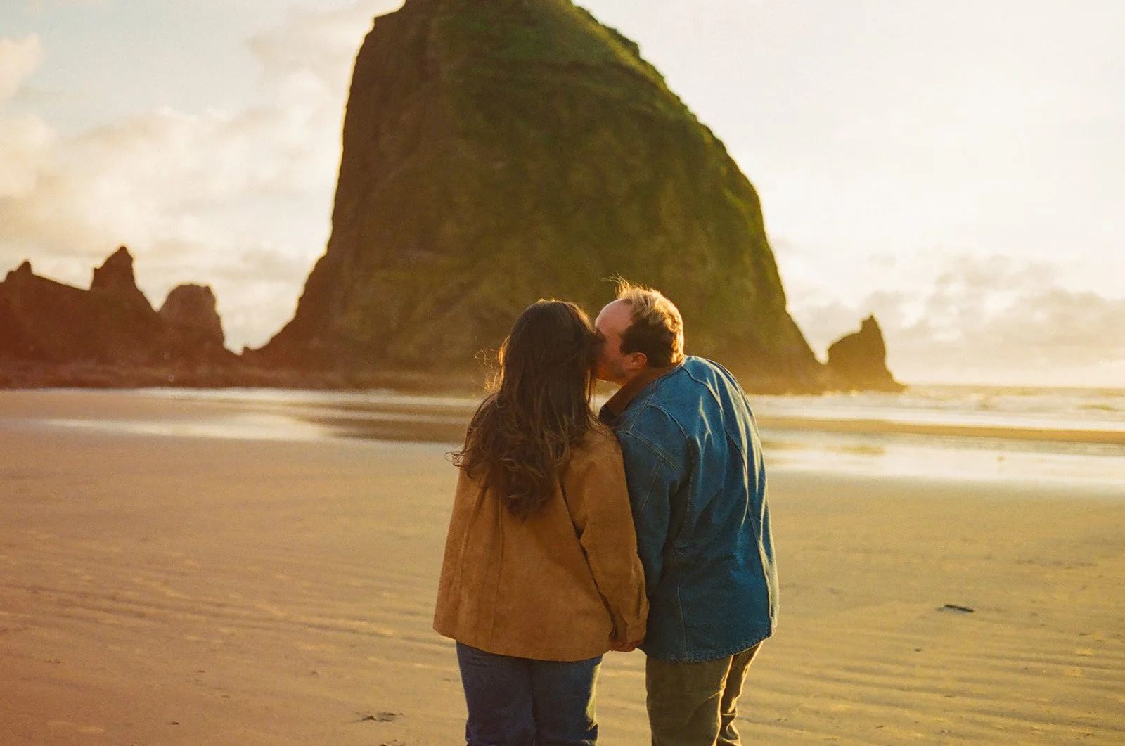 A couple choosing where to take engagement photos on the beach