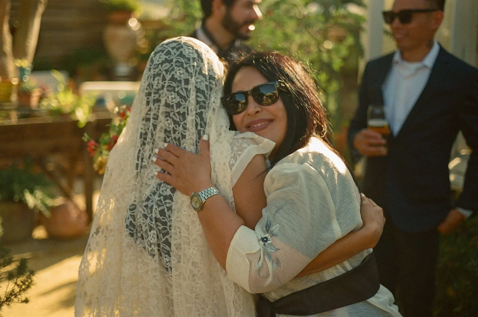 A bride hugging a wedding guest