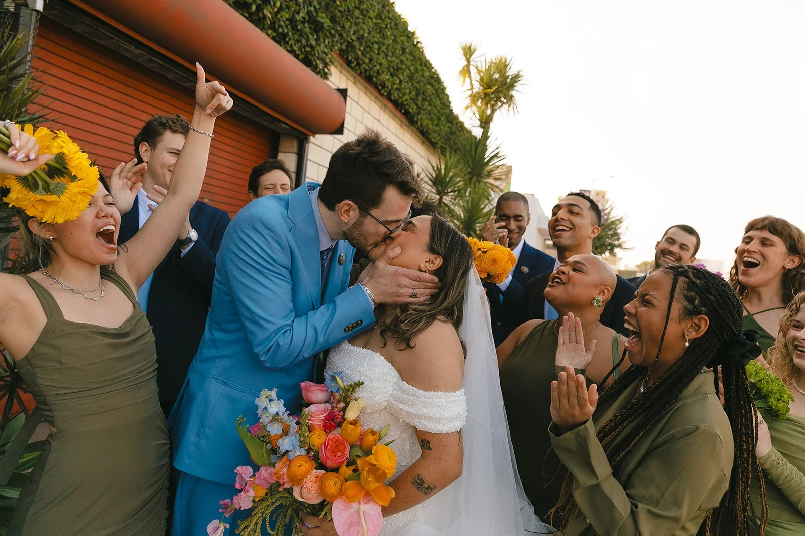 A bride and groom kissing during wedding party photos
