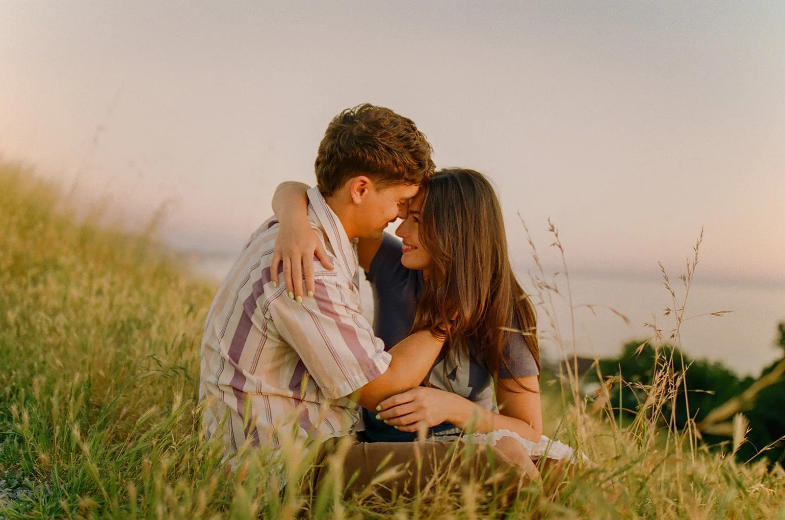 A couple smiling at each other in Laguna Beach engagement photos