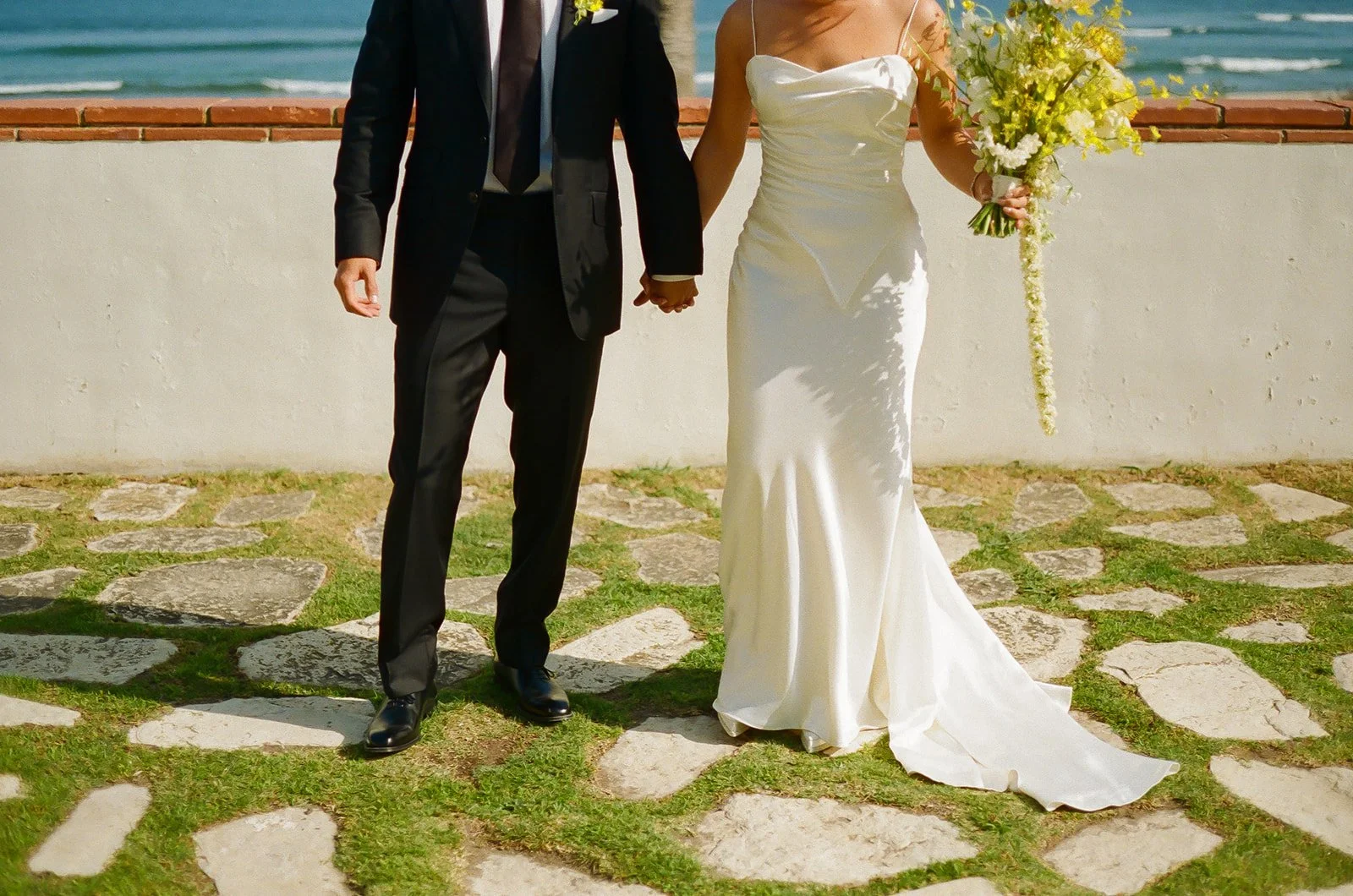 A bride and groom taking wedding portraits at Adamson House