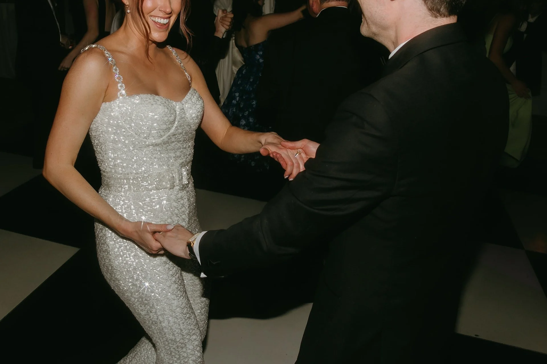 Bride dancing with her husband on the reception dance floor in a beaded wedding dress at The Ranch at Laguna Beach wedding.