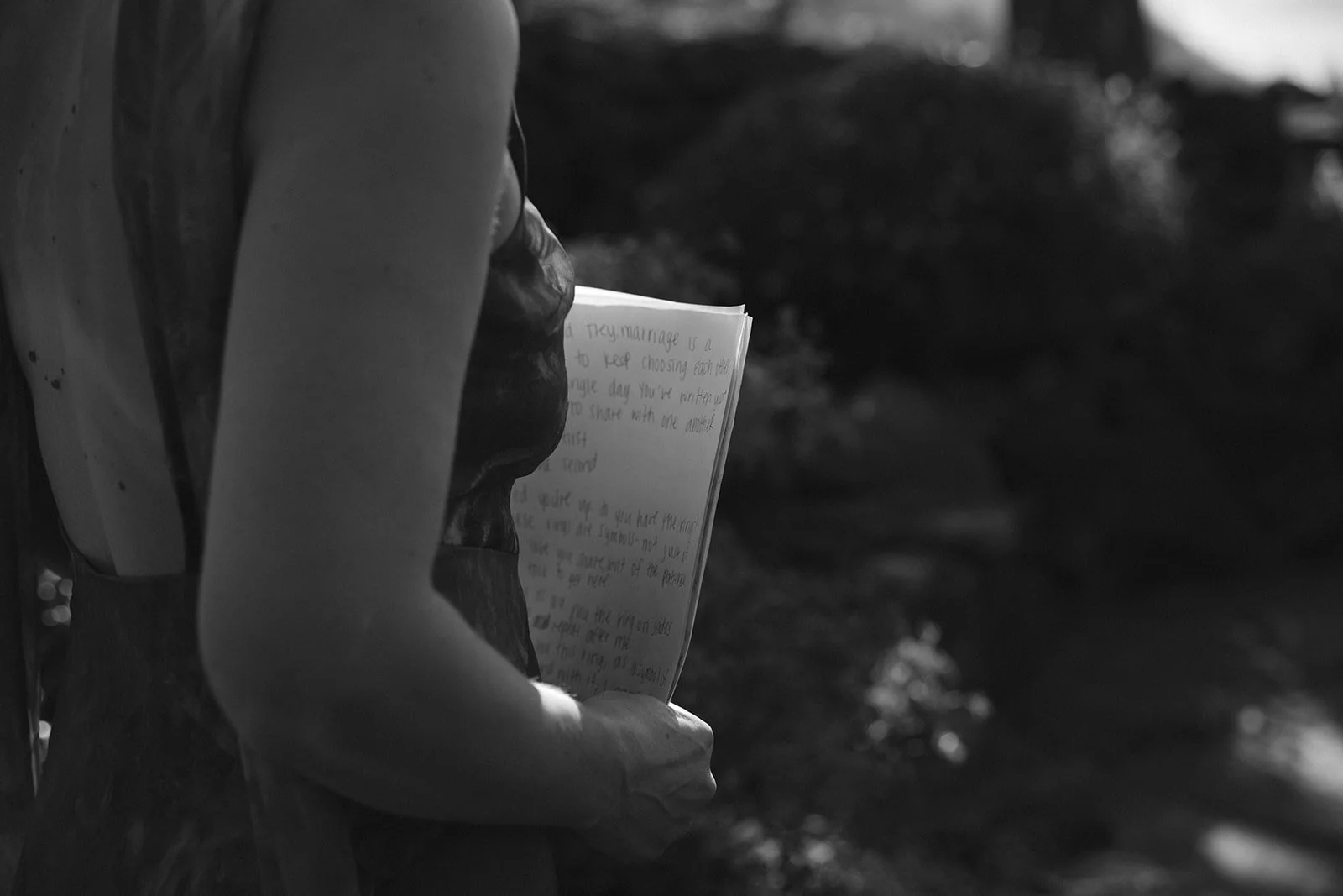 An officiant holding a speech for a memorial speech during a wedding ceremony