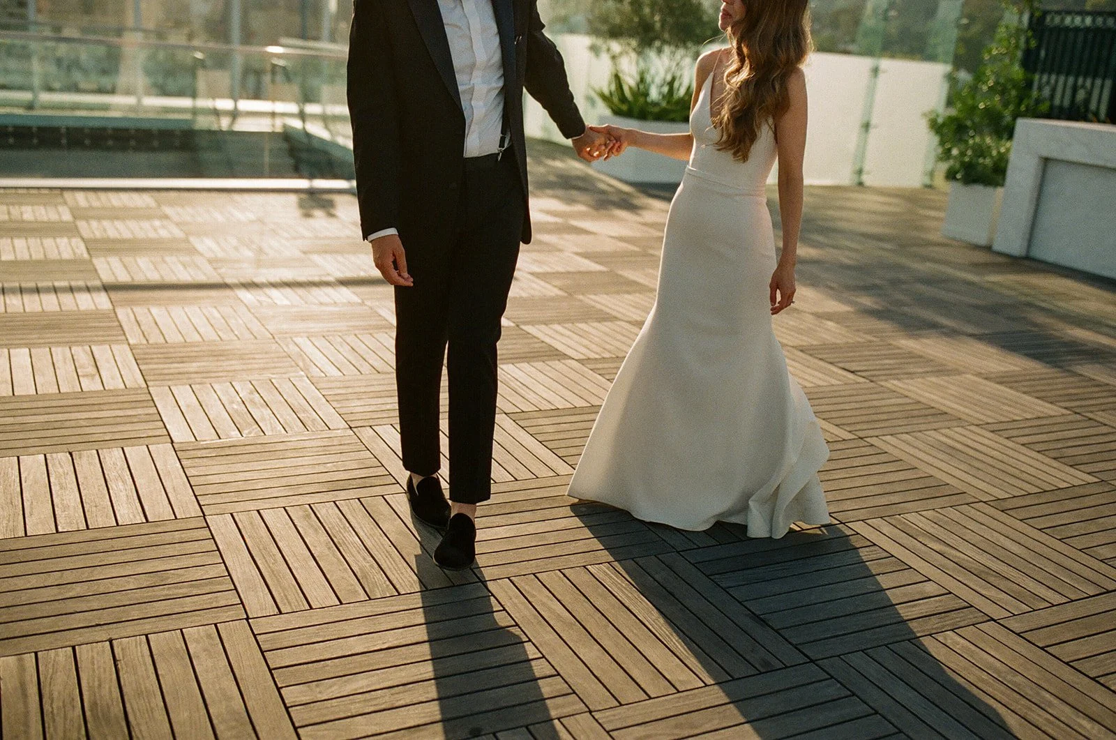 A couple posing for wedding photos on the rooftop of their West Hollywood wedding venue