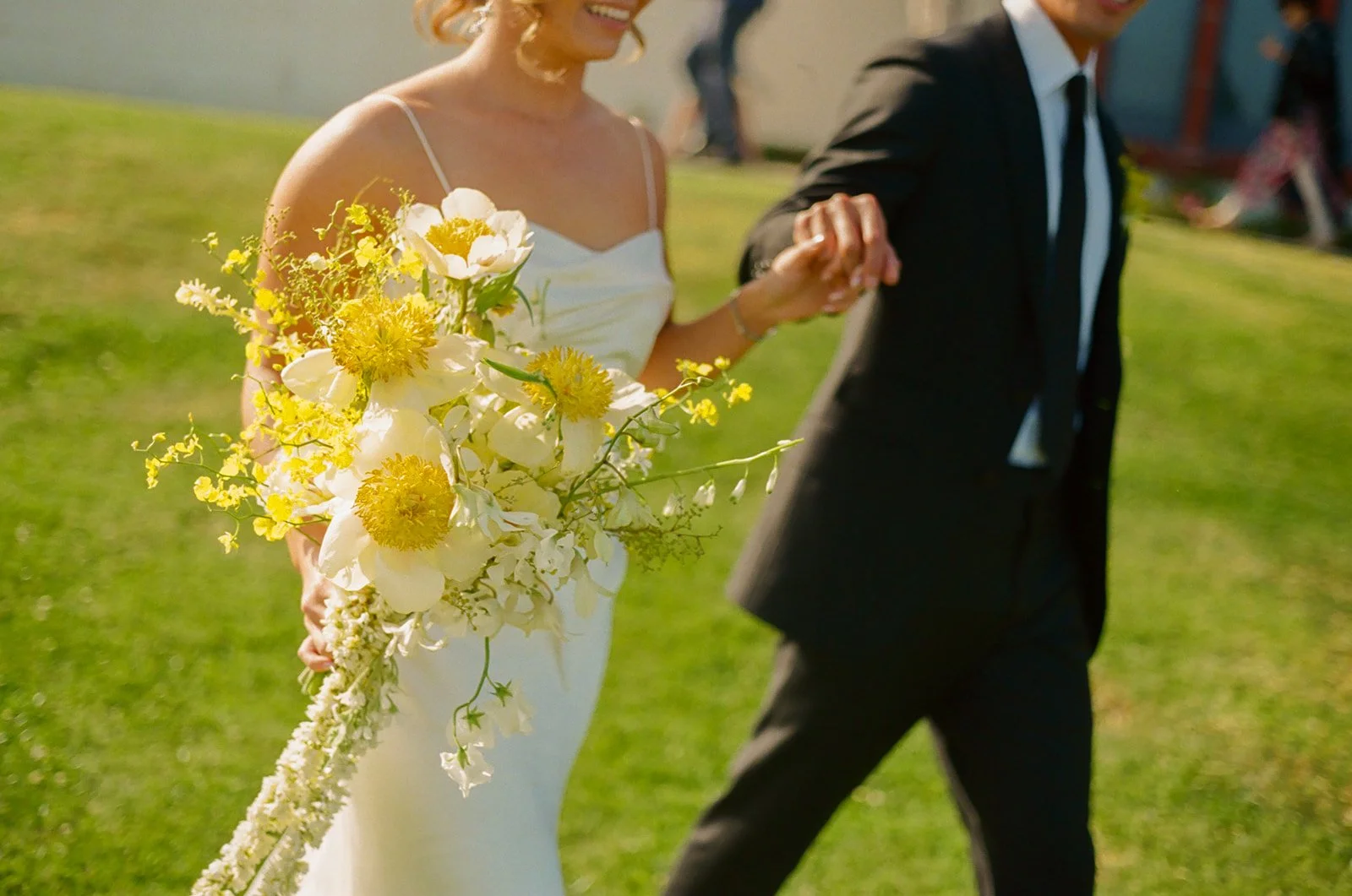 A bride and groom walking hand-in-hand