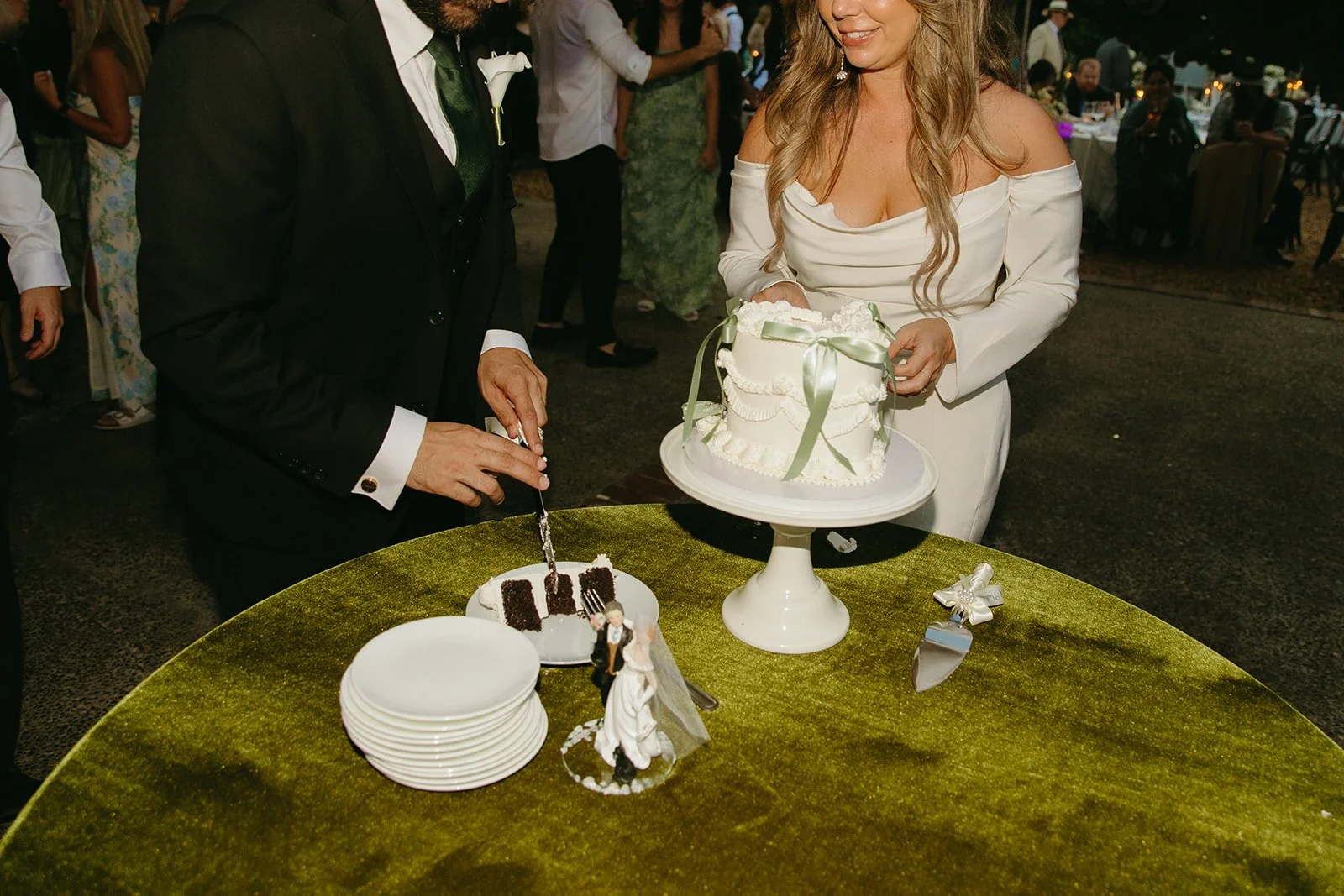 A bride and groom cutting their cake