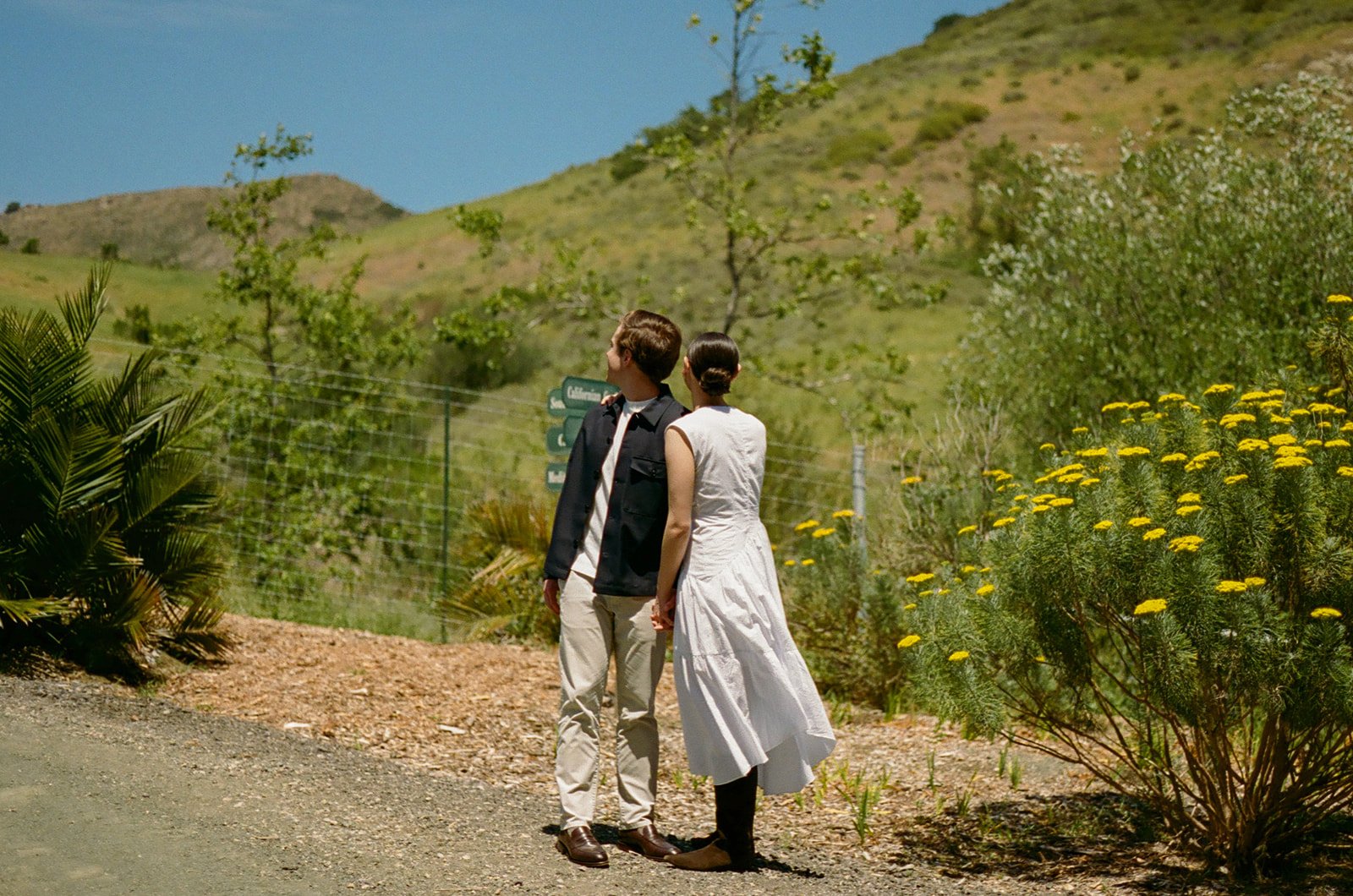 A couple taking San Luis Obispo engagement photos in Cal Poly Botanical GArdens