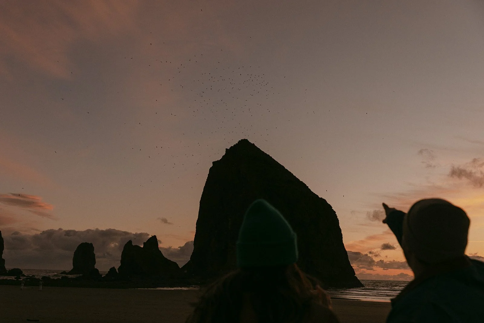 A couple choosing where to take engagement photos on Cannon Beach