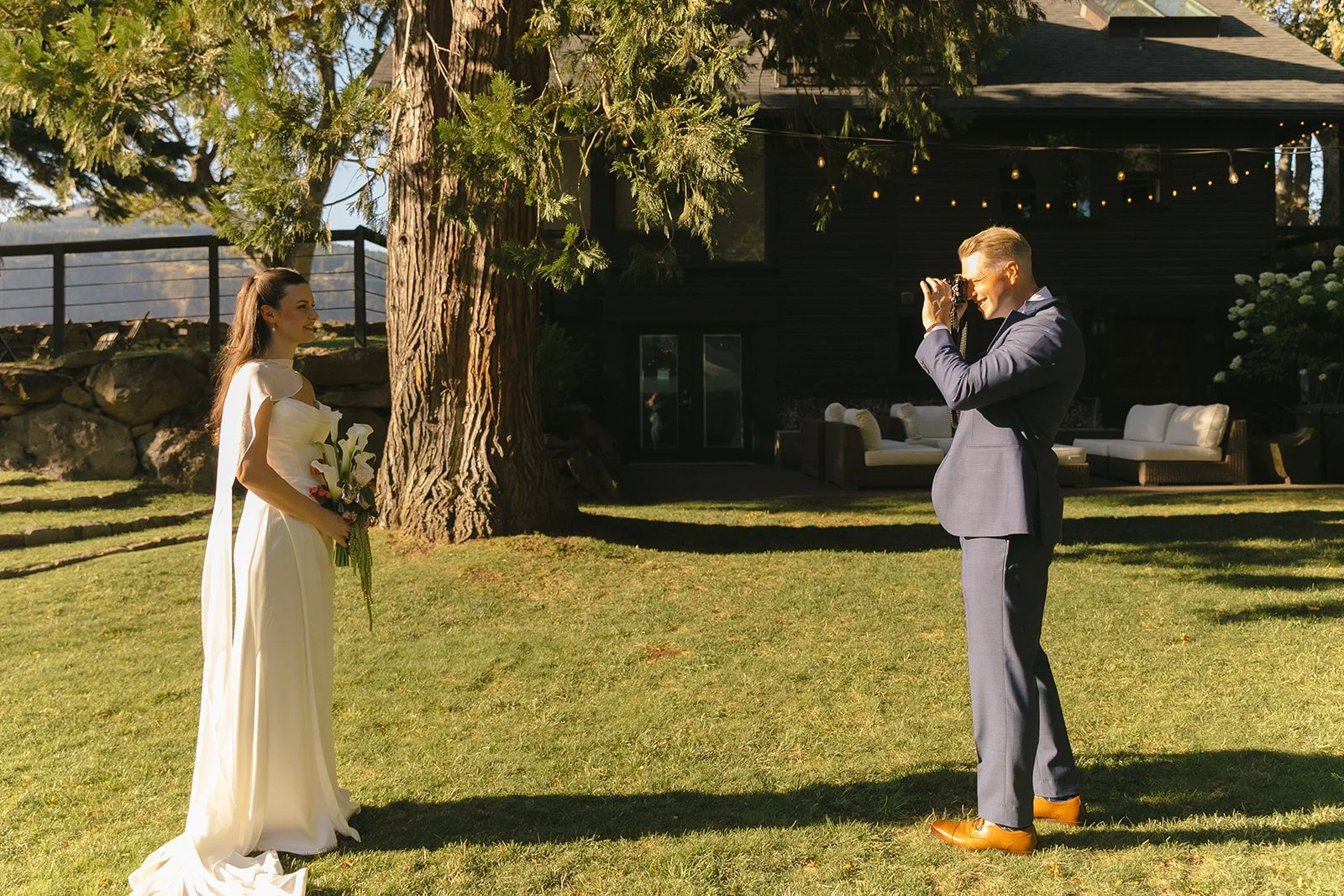 A groom taking photos of a bride with her dad's old camera as memorial ideas for weddings