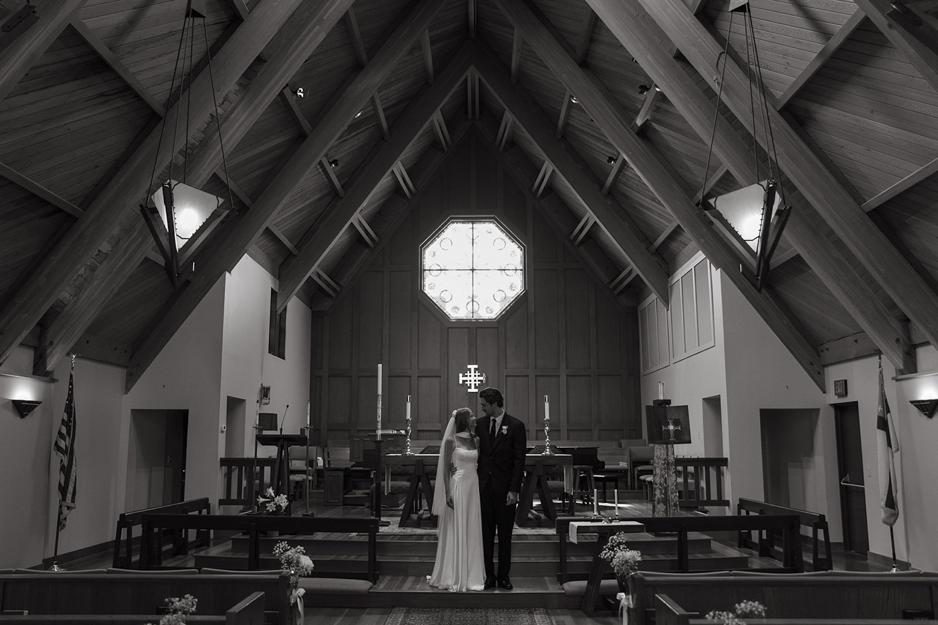 Bride and groom standing together at the altar inside a wooden chapel during their Laguna Beach wedding ceremony.