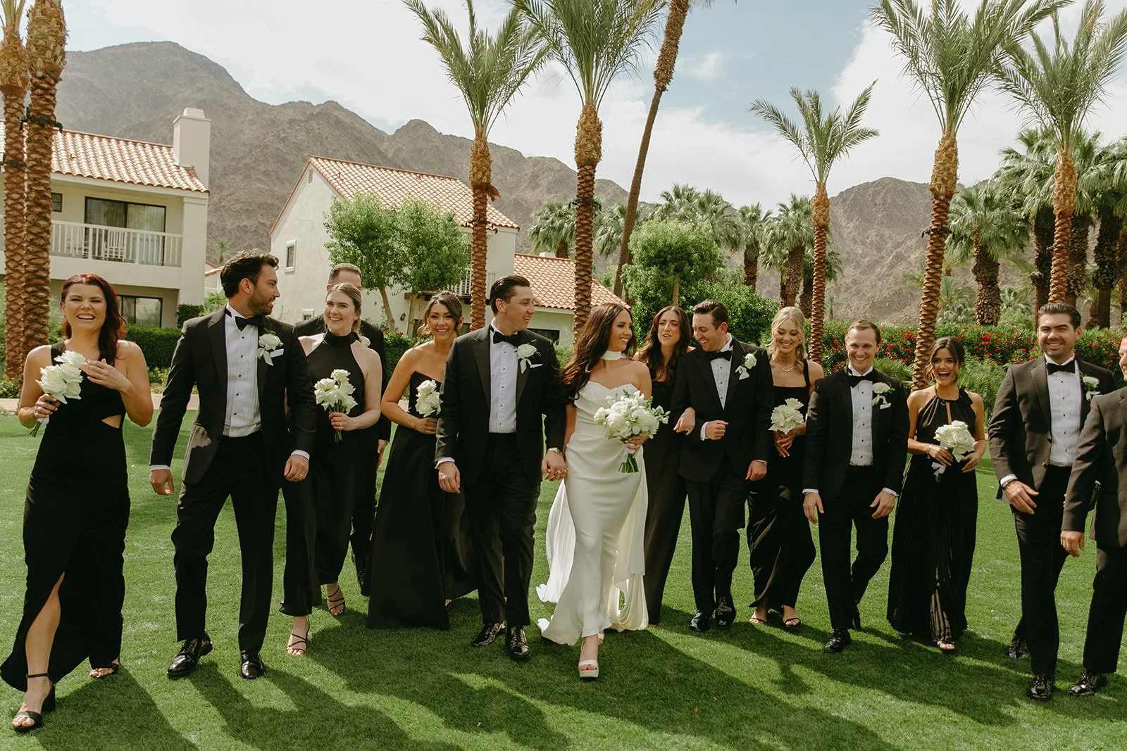A wedding party walking across the lawn at PGA West