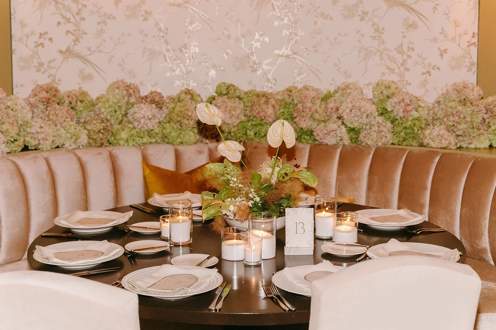 A wedding reception setup with pink and green decor