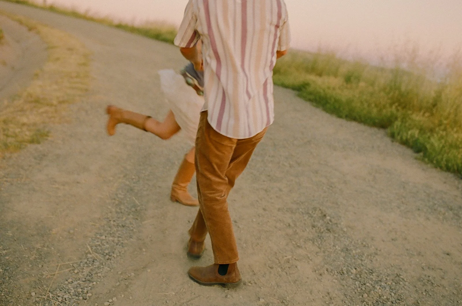 A couple spinning around in their film engagement photos