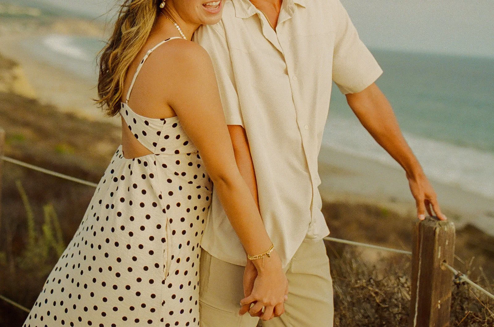 A couple in neutral engagement photo outfits showing what to wear for engagement photos