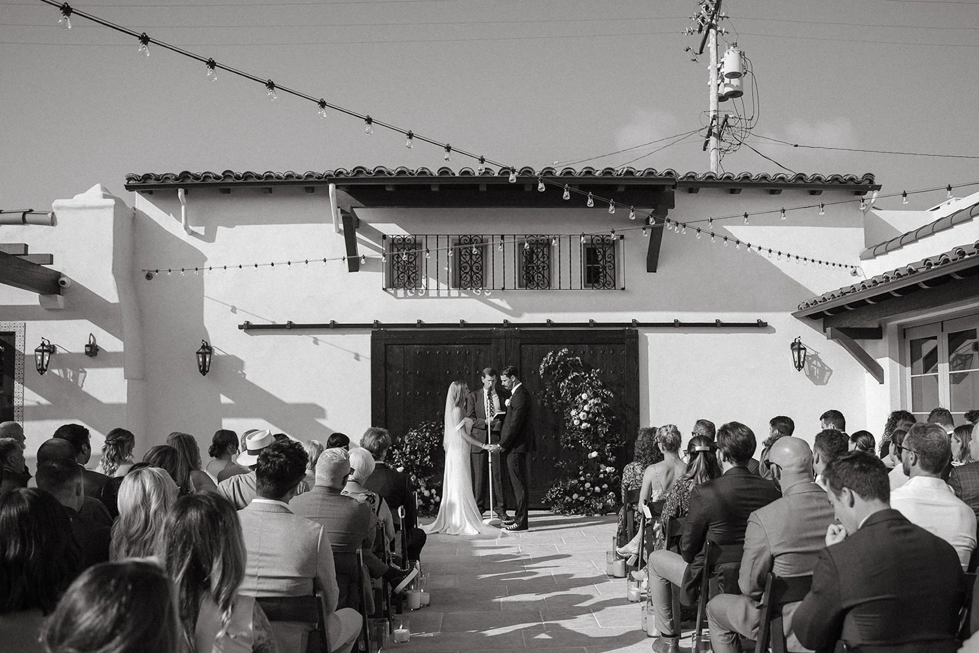 Black and white image of the bride and groom standing at the alter during their wedding ceremony at a San Clemente Wedding Venue