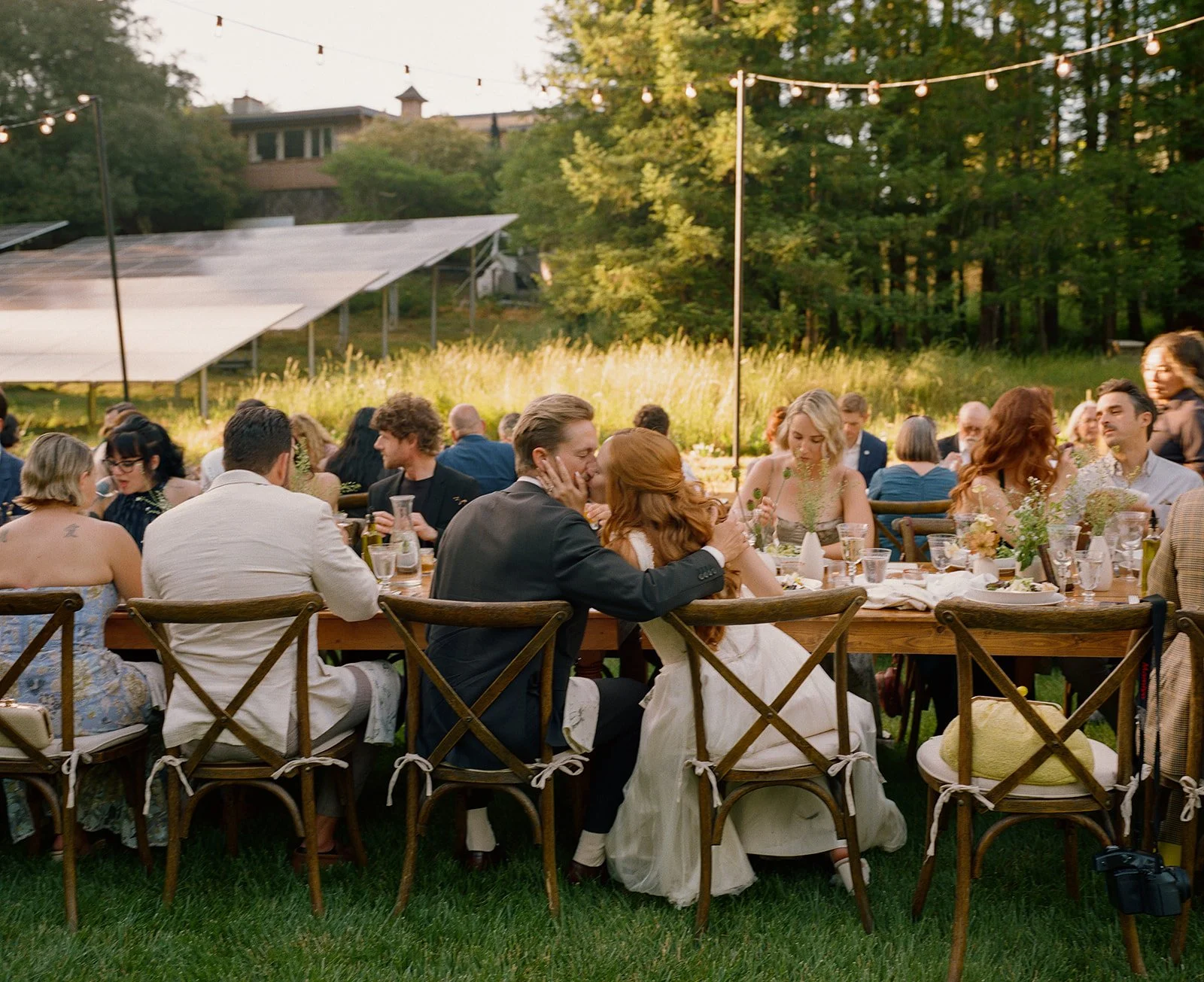 A bride and groom kissing at their wedding reception
