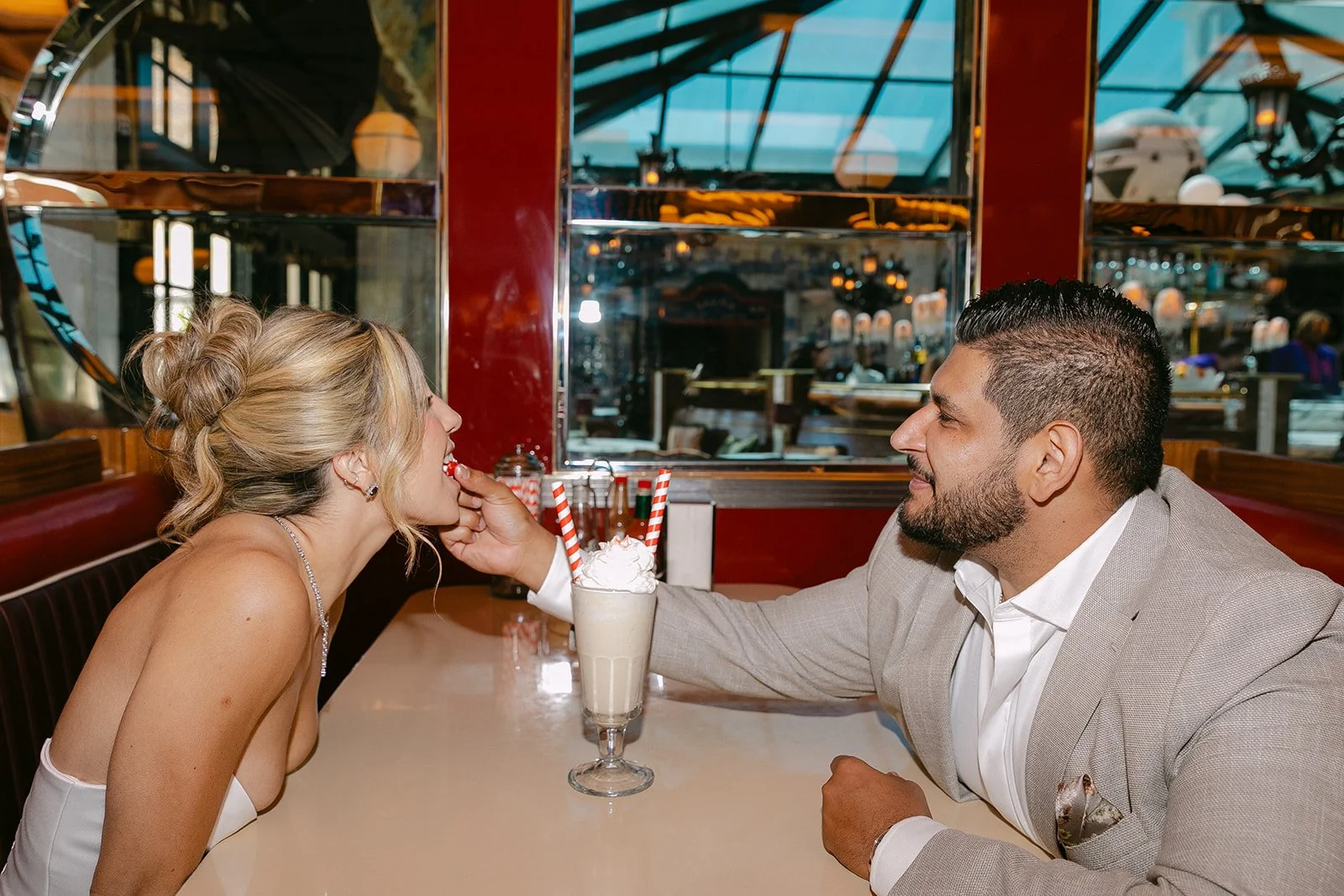 A couple splitting a milkshake at Lafayette Hotel