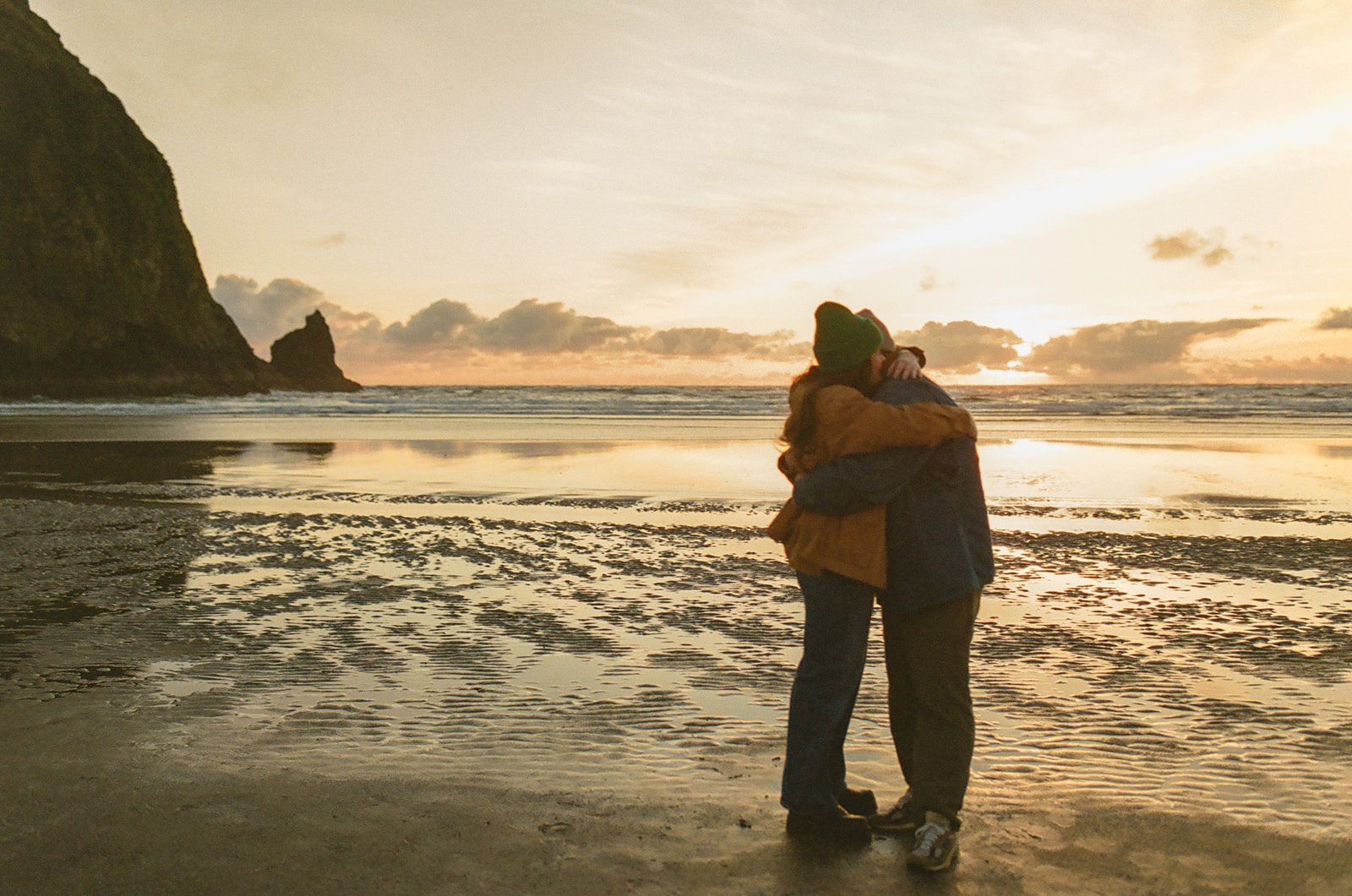 A couple hugging during their beach engagement photos
