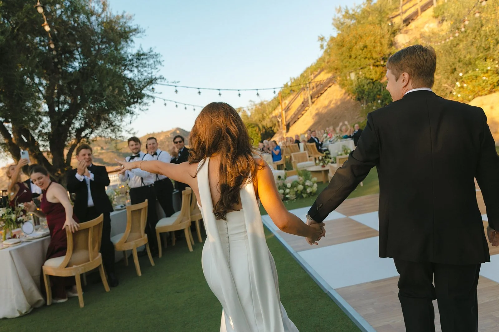 A couple entering their wedding reception at Cielo Farms