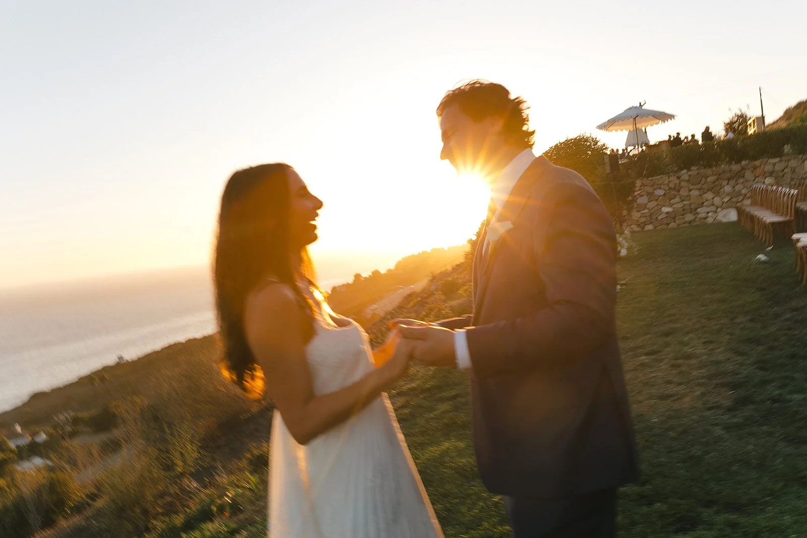 A bride and groom posing for sunset wedding photos