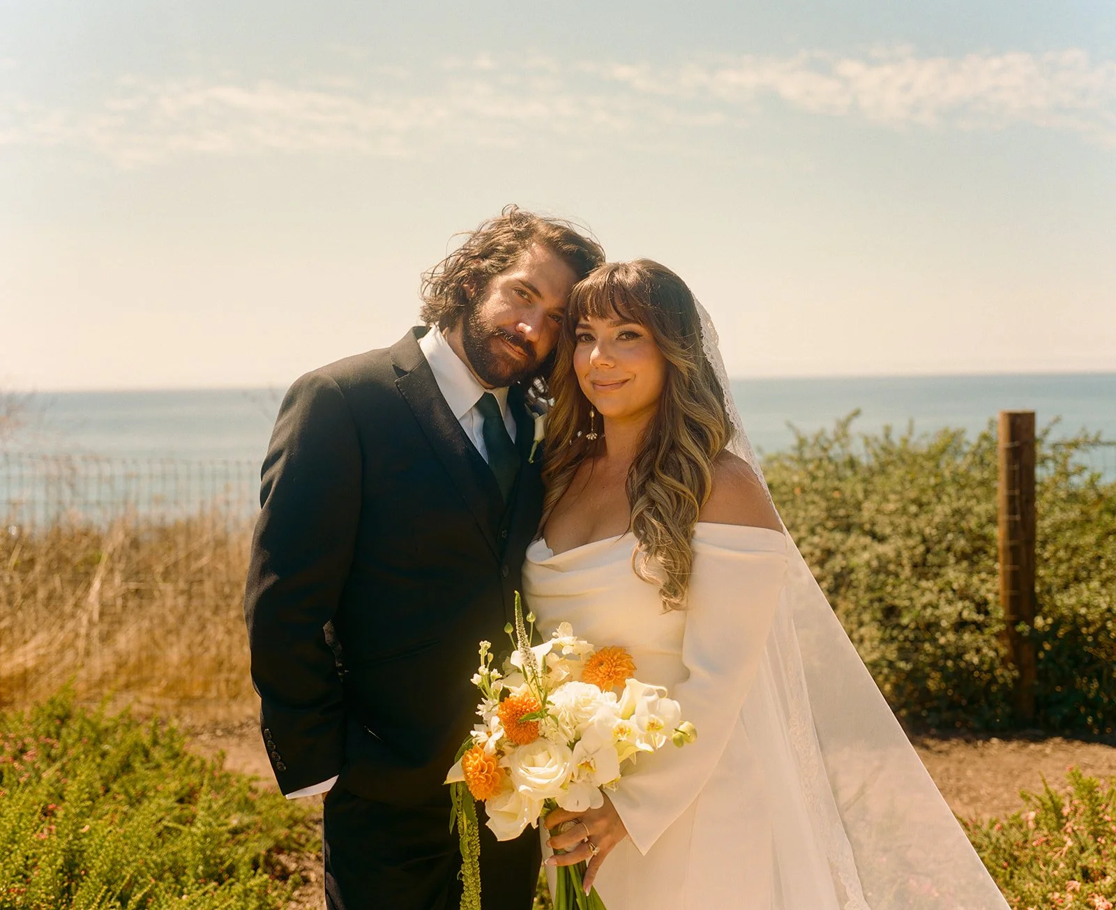 A bride and groom posing for wedding portraits