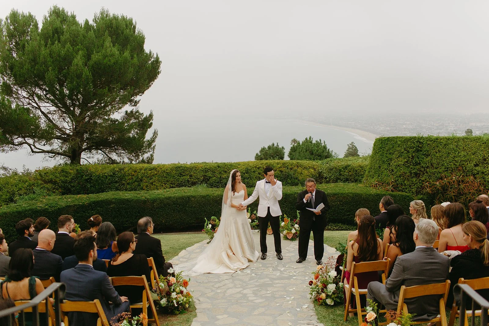Guests seated during the ceremony with the couple centered against a scenic backdrop at a Historic Wedding Venue.