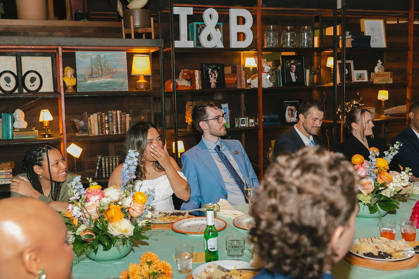 A bride and groom laughing at their wedding reception