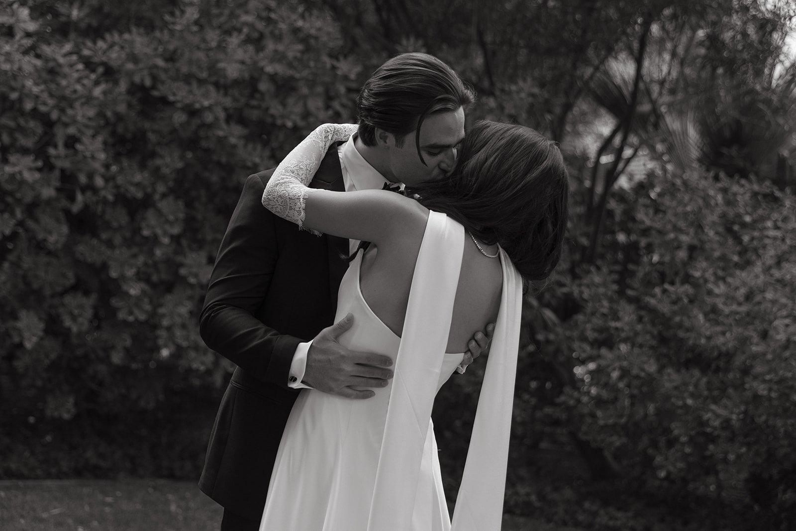 A bride and groom in a black and white palm springs wedding photo