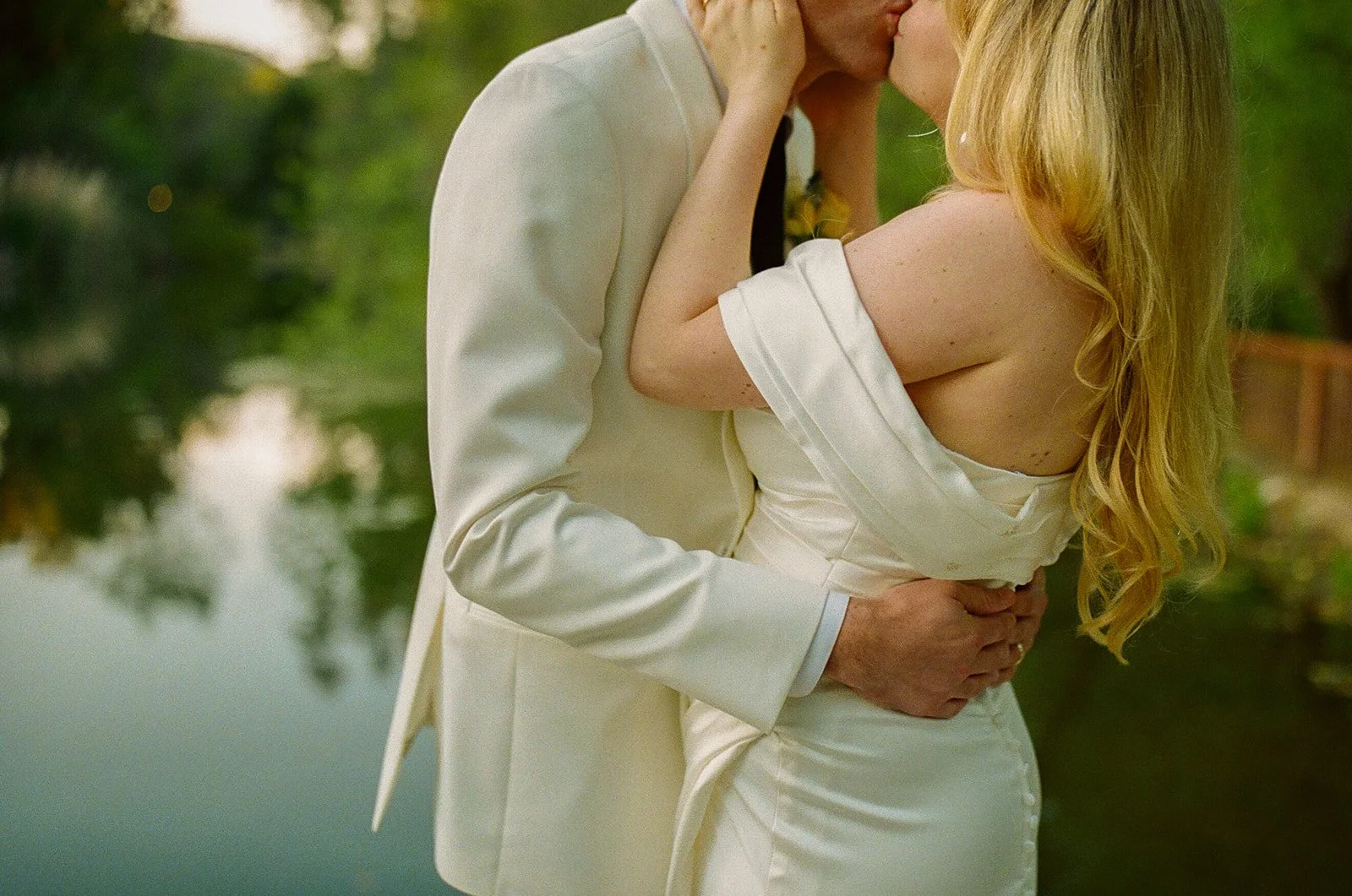 A bride and groom kissing in wedding photos at their Malibu wedding venue
