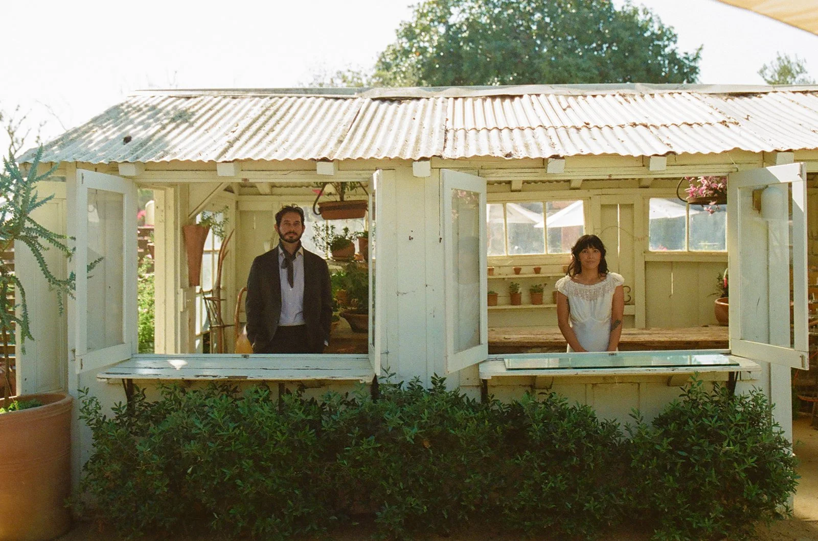A bride and groom taking photos at their dinner party wedding