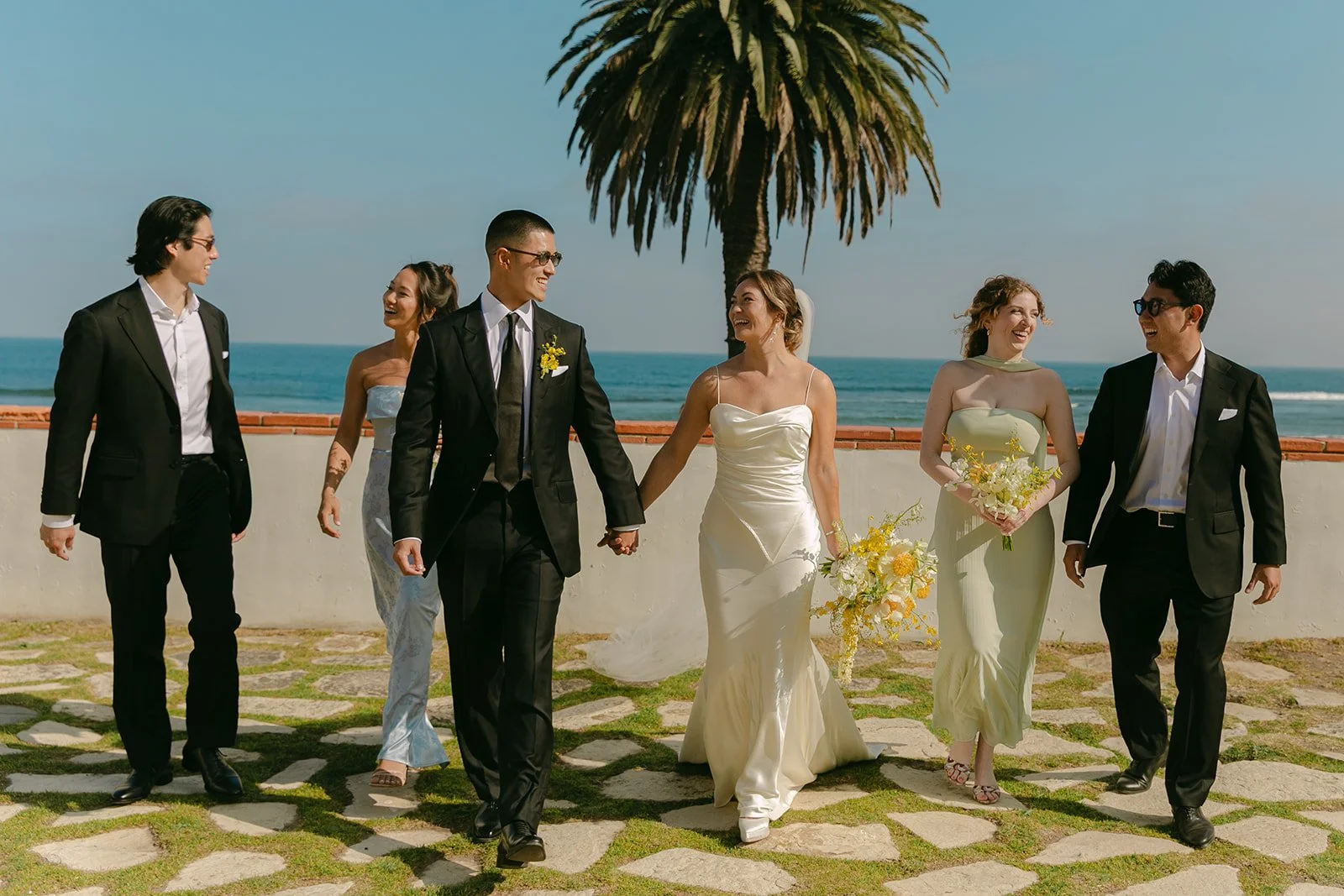 A bride and groom posing with their bridal party