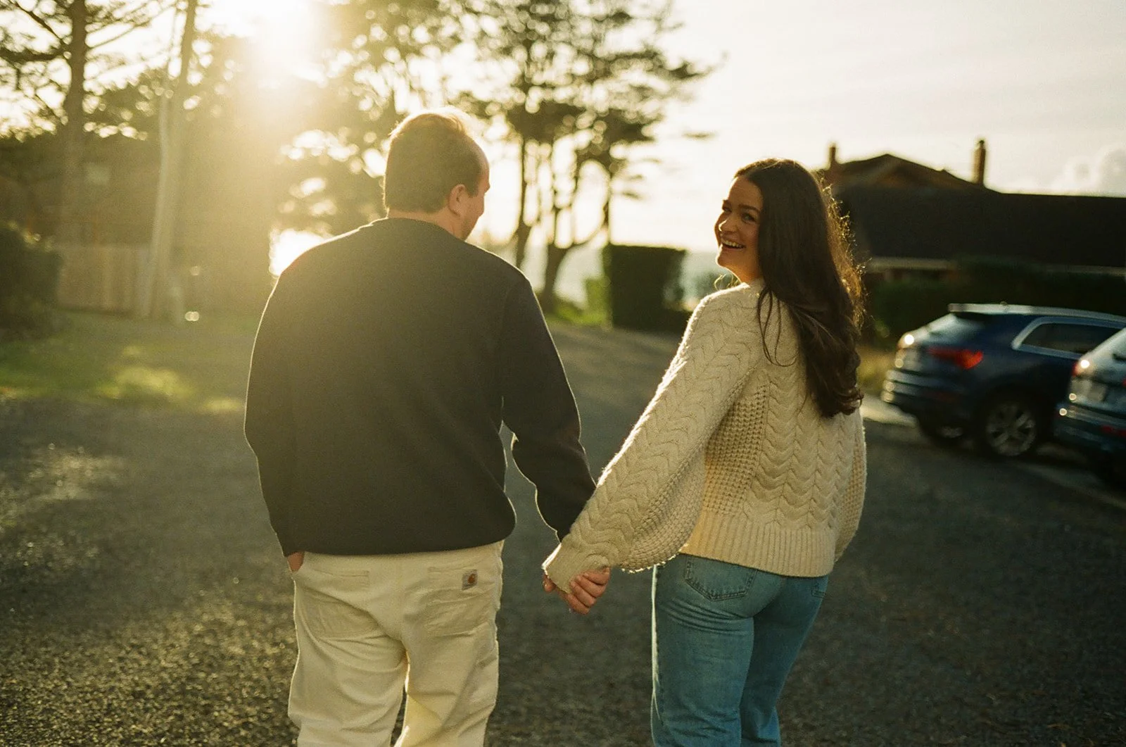 A couple walking hand-in-hand during engagement photos