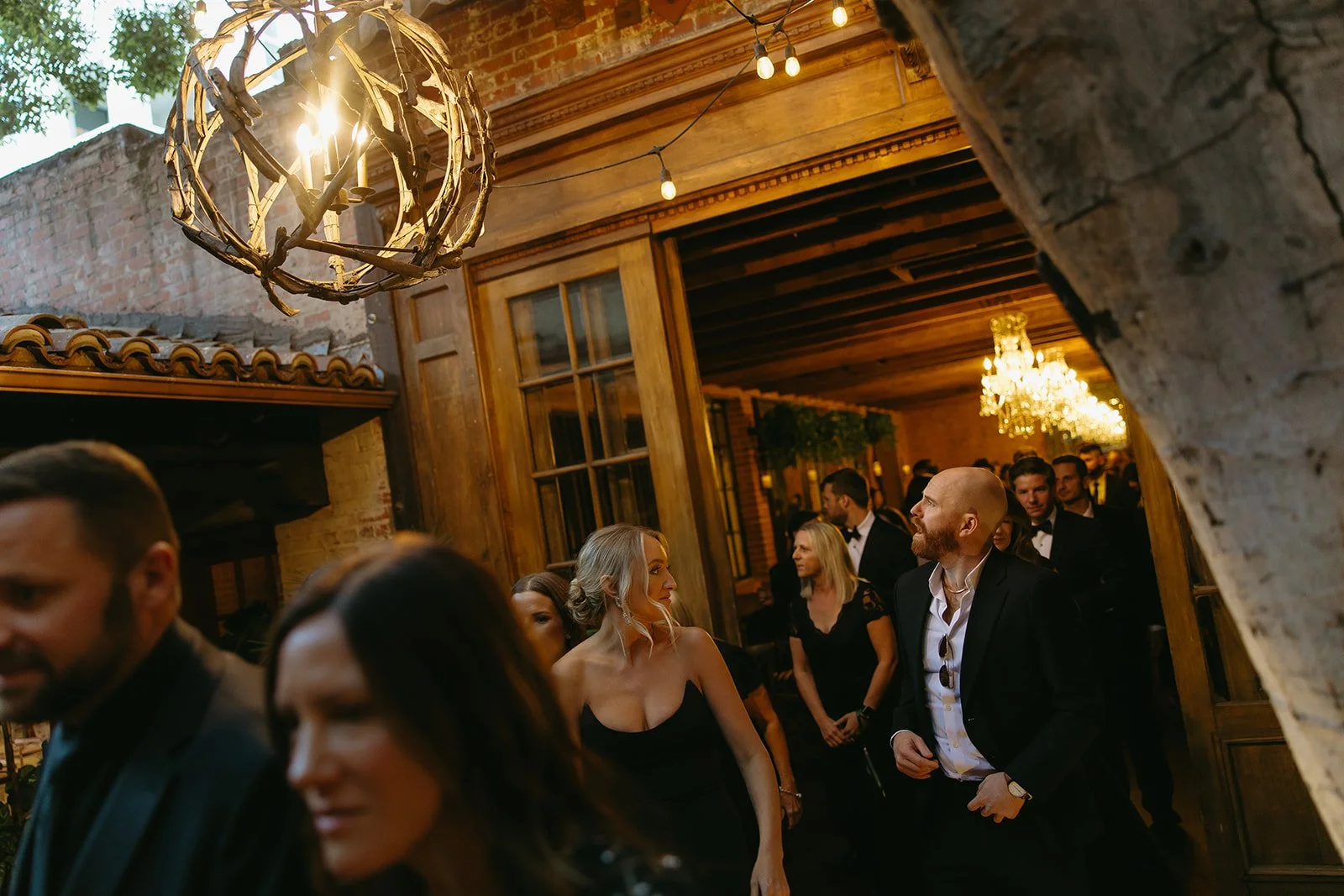 A candid photo of the wedding guests walking into the Carandolet House, a DTLA wedding venue