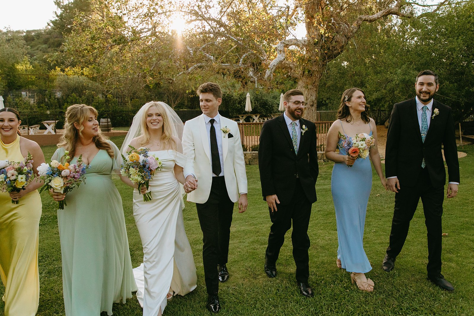 A bridal party walking across the lawn at a Malibu wedding venue