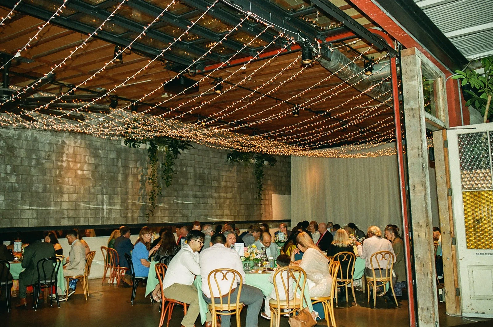 An indoor wedding reception on film at smogshoppe